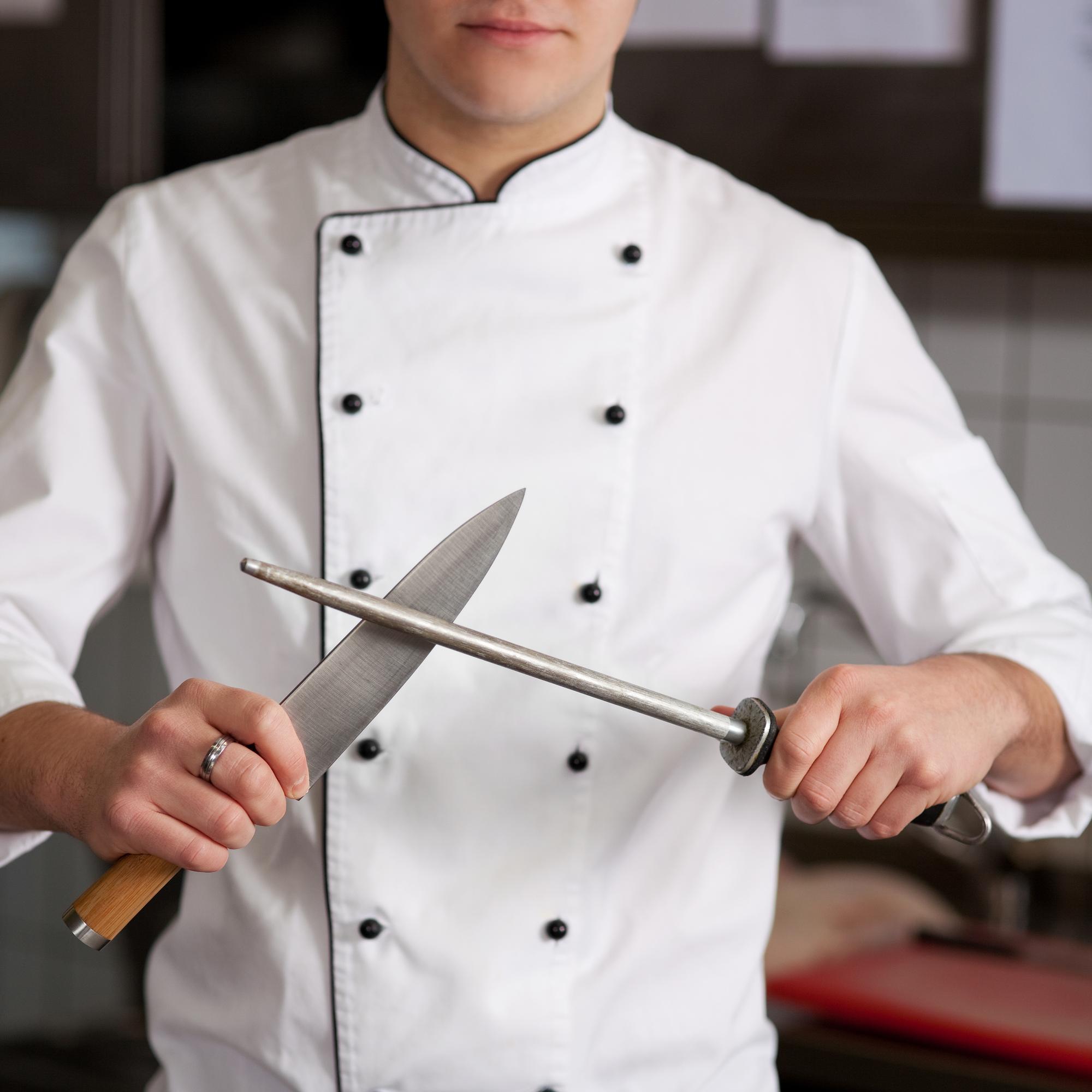 Chef demonstrating knife technique to attendees